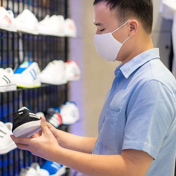 Image of man shopping for running shoe