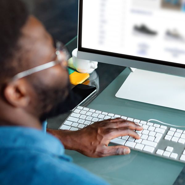 Image of a man reviewing products on a computer
